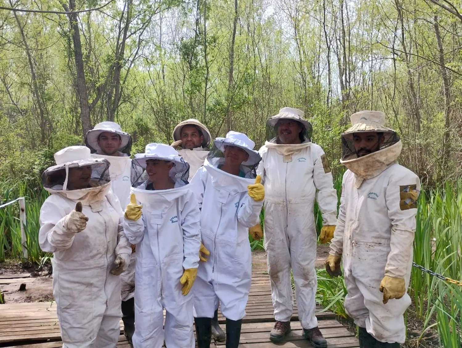El equipo con los trajes puestos, en la pasarela del apiario del Delta